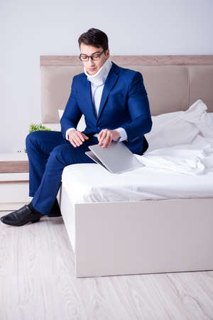 Businessman with neck injury working from homeの写真素材