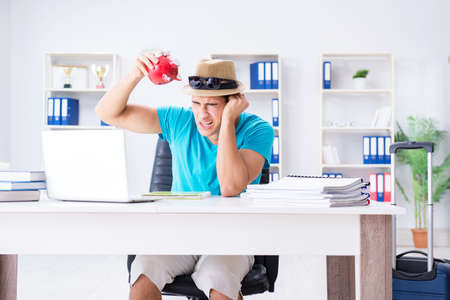 Businessman preparing for vacation in the officeの写真素材