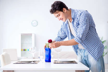 Man alone preparing for romantic date with his sweetheartの写真素材