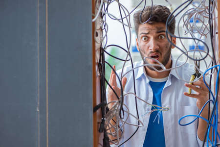 Computer repairman working on repairing network in IT workshop