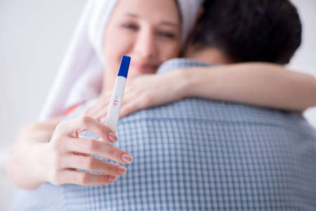 Wife and husband looking at pregnancy testの写真素材