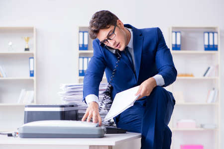 Businessman making copies in copying machineの写真素材