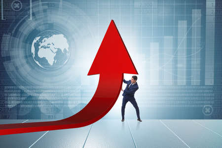 Businessman supporting growtn in economy on chart graphの写真素材