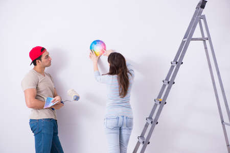 Young family doing renovation at home  - painting wallsの写真素材