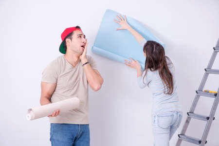 Young family doing renovation at home with new wallpaperの写真素材