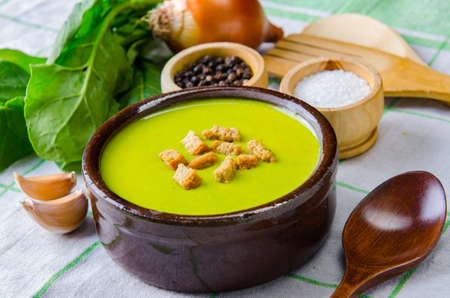 Spinach soup served on wooden board の写真素材