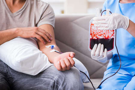 Patient getting blood transfusion in hospital clinicの写真素材