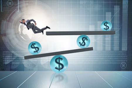 Businessman balancing in financial dollar conceptの写真素材