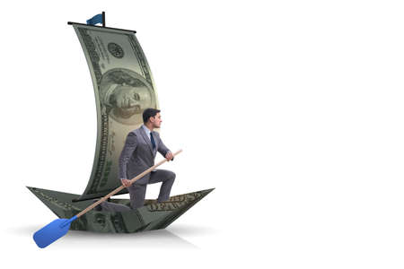 Businessman rowing on dollar boat in business financial conceptの写真素材