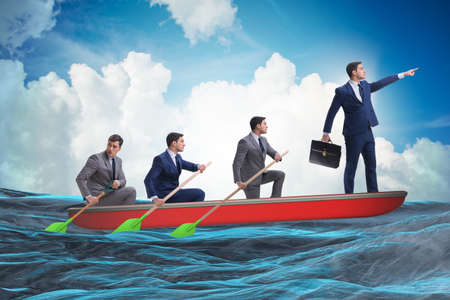 Team of businessmen in teamwork concept with boatの写真素材
