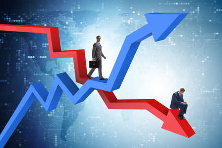 Businessman with charts of growth and declineの写真素材