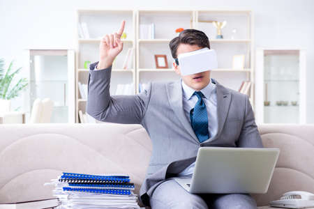 Businessman with virtual reality glasses in modern technology coの写真素材
