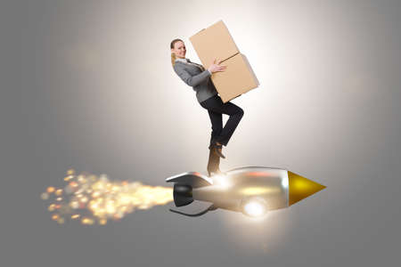 Woman flying rocket and delivering boxesの写真素材