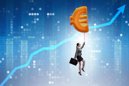 Businesswoman flying on euro sign inflatable balloonの写真素材