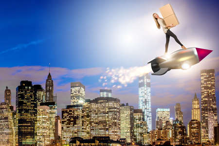 Woman in fast box delivery service on rocketの写真素材