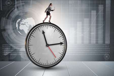 Businesswoman in time management conceptの写真素材