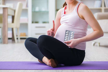 Pregnant woman exercising in anticipation of child birth