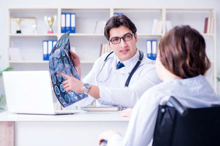 Doctor explaining to patient results of x-ray imagingの写真素材