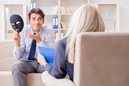 Young man visiting psychiatrist doctor for consultationの写真素材