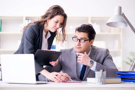 Sexual harassment concept with man and woman in officeの写真素材