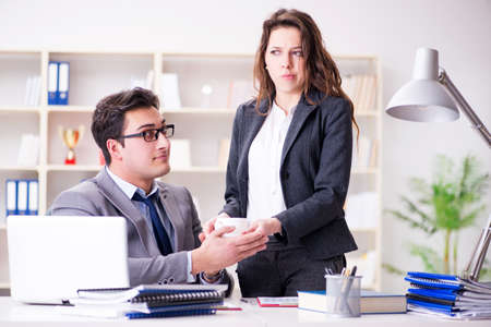 Sexual harassment concept with man and woman in officeの写真素材