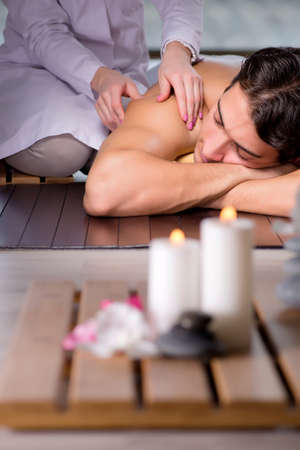 Young handsome man during spa procedureの写真素材