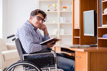 Disabled student studying at home on wheelchairの写真素材