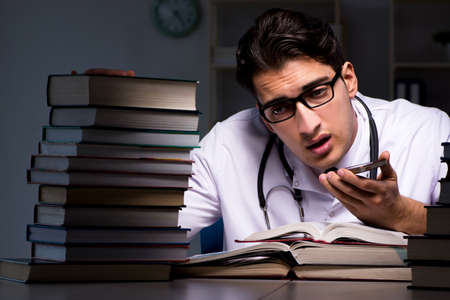 Medical student preparing for university exams at nightの写真素材