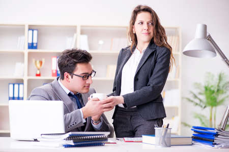 Sexual harassment concept with man and woman in officeの写真素材