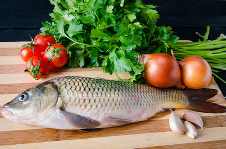 Uncooked fish on cutting board in meal preparation conceptの写真素材