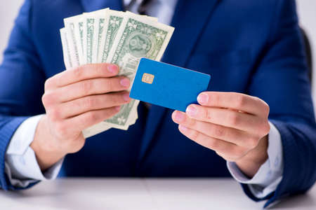 Businessman holding dollar money and credit cardの写真素材