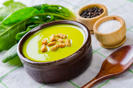 Spinach soup served on wooden board の写真素材