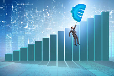 Businessman flying on euro sign inflatable balloonの写真素材