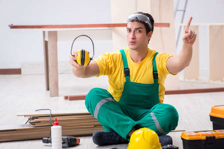 Worker showing the importance of wearing noise cancelling headphoneの写真素材