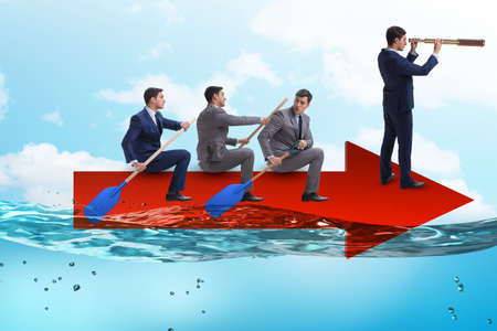 Teamwork concept with businessmen on boatの写真素材