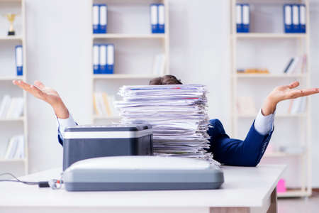 Businessman making copies in copying machine