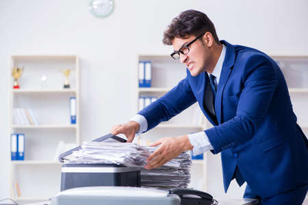 Businessman making copies in copying machineの写真素材