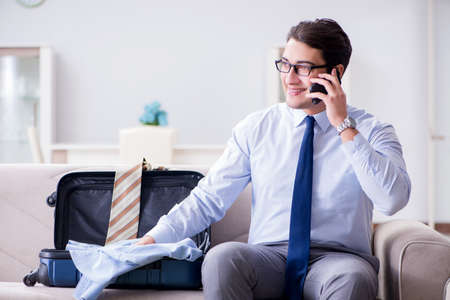 Businessman preparing packing for business tripの写真素材