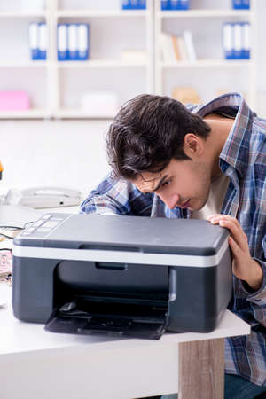 Hardware repairman repairing broken printer fax machine