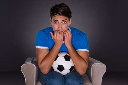 Man watching sports on gray backgroundの写真素材