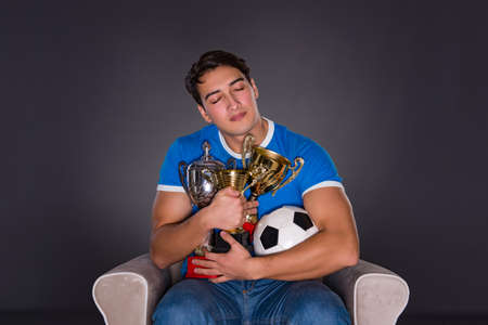 Man watching sports on gray backgroundの写真素材