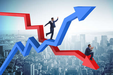 Businessman with charts of growth and declineの写真素材