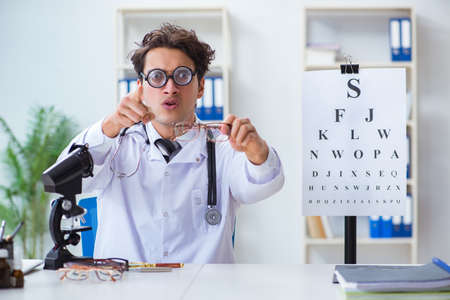 Funny eye doctor in humourous medical conceptの写真素材