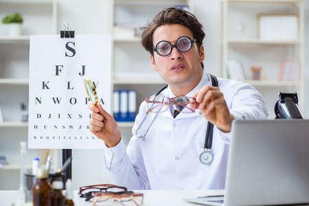 Funny eye doctor in humourous medical conceptの写真素材