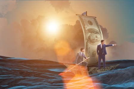 Business partnership with businessmen sailing on dollar boatの写真素材