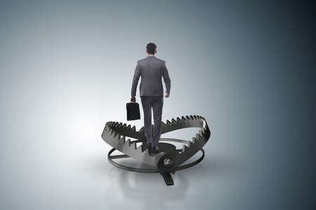 Man caught in mouse trap in risk business conceptの写真素材