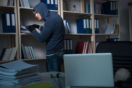 Young man in industrial espionage conceptの写真素材