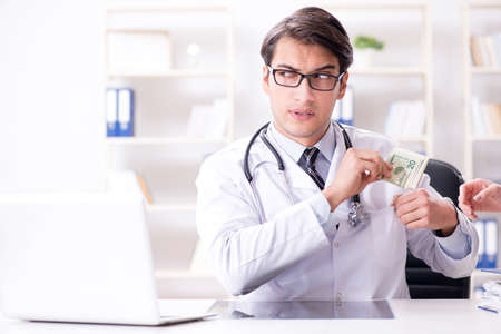Doctor in corruption concept with being offered bribeの写真素材
