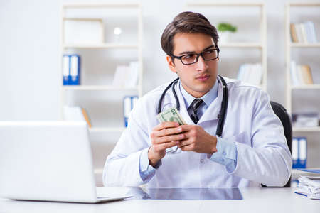 Doctor in corruption concept with being offered bribeの写真素材