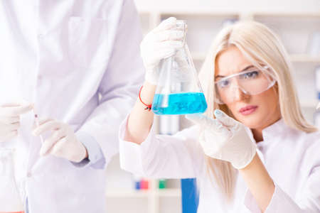Young woman chemist working in clinic labの写真素材